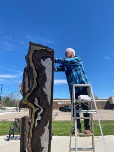 Artist working with sculpture on the Sculpture Walk