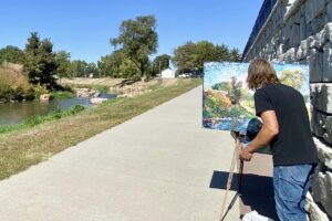 Artist painting en plein air at the river walk
